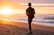© Oleksandr Stalovierov/Stocksy - Straching before morning run on the beach.