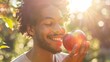 © MAY - A man holding a crisp, juicy apple, taking a bite and smiling, with the sunlight highlighting the freshness of the fruit.