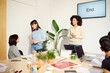 © Guille Faingold/Stocksy - Casual Business Discussion After Presentation