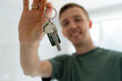 © Ivan Haidutski/Stocksy - Close up male hand holding key from new home / apartment.