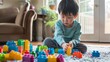 © esp2k - A young boy is playing with a large pile of colorful legos