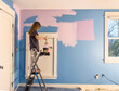 © Raymond Forbes LLC/Stocksy - Young girl Painting her bedroom in renovation of room in house