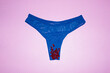 © Colour Laboratory/Stocksy - Contemporary photo of underpants and red pearl blood with flashlight