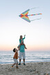 © Ani Dimi/Stocksy - Family Playing With A Kite