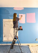 © Raymond Forbes LLC/Stocksy - Young girl Painting her bedroom in renovation of room in house diy