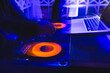 © VICTOR TORRES/Stocksy - Vibrant DJ session with colorful lighting at nightclub