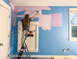 © Raymond Forbes LLC/Stocksy - Happy Young girl Painting her bedroom in renovation of room in house