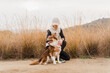 © Nuria Seguí/Stocksy - Loving Woman Embracing Her Dog Outside