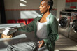 © Lupe Rodríguez/Stocksy - black woman folding clean clothes in a laundry