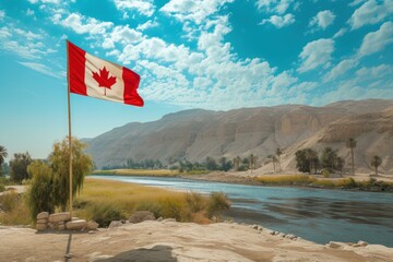 Poster - Vibrant canadian flag flutters against a serene desert backdrop with sky, river, and mountains