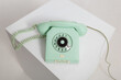 © Andriy Bezuglov/Stocksy - Closeup view at vintage mint colored rotary telephone