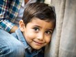 © Mohammad - A photorealistic close-up of a Latino boy peeking out from behind his mother's leg, a shy smile peeking through his fingers, one eye cautiously observing the world.