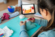 © nomad studio/Stocksy - Creative woman handcrafting with online tutorial