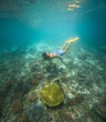 © Pedro Merino/Stocksy - Man snorkeling in Indonesia