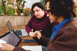 © Edward Córdoba / Andréas Sichel/Stocksy - A young man and woman working remotely on a tablet