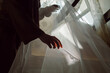 © Anna Malkova/Stocksy - hands smoothing fabric against the light
