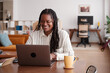 © Malquerida Studio/Stocksy - Cheerful woman using laptop