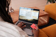 © Malquerida Studio/Stocksy - Anonymous making online payment for booking vacation