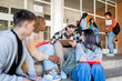 © Santi Nuñez/Stocksy - Diverse Students Engaged in Campus Collaboration
