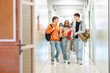 © Santi Nuñez/Stocksy - Students Walking Through high school Hallway