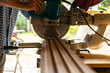 © Raymond Forbes LLC/Stocksy - Construction woodworker Carpenter cutting wood with saw