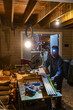 © Raymond Forbes LLC/Stocksy - Construction worker cutting wood with jigsaw home renovation
