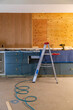 © Raymond Forbes LLC/Stocksy - Home improvement project kitchen construction with drill