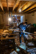 © Raymond Forbes LLC/Stocksy - Construction Carpenter cutting wood with saw at night
