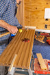 © Raymond Forbes LLC/Stocksy - Blue Collar worker Carpenter building wall with tools in kitchen