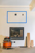 © Raymond Forbes LLC/Stocksy - House Construction with gas fireplace and vacuum