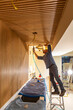 © Raymond Forbes LLC/Stocksy - Construction Carpenter building wall with nail gun