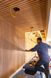 © Raymond Forbes LLC/Stocksy - Construction Carpenter building Vertical wood paneling wall
