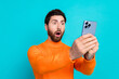 © deagreez - Photo of shocked bearded young man wear orange stylish clothes isolated on cyan color background