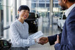 © Jovo Jovanovic/Stocksy - Car salesperson closing sale with handshake