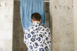 © Lea Jones/Stocksy - teen boy drying his face his face after washing it