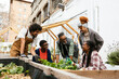 © BONNINSTUDIO/Stocksy - Group of volunteers working in community garden