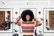 © Santi Nuñez/Stocksy - hairdresser talking to client after cutting and styling afro hair