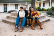 © Kelsey - Beautiful family with three young boys sit on steps outside California adobe