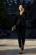 © Eyes on Asia/Stocksy - asian business woman with phone in street