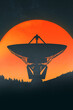 © Marcos Osorio/Stocksy - Twilight radio telescope silhouette against orange sky