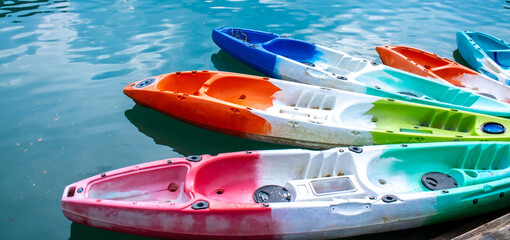 Wall Mural - Kayaks moored for rent on Lake Cheo Lan in Thailand. Kayaking on the lake. Tourist entertainment.