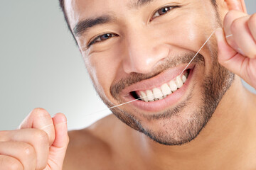 Sticker - Oral, floss and dental hygiene with model in studio on white background cleaning teeth for healthy gums. Man, healthcare routine and mouth portrait with guy flossing to remove plaque or gingivitis