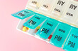 © Jeff Wasserman/Stocksy - Pill and Capsule Organizer on Pink Background
