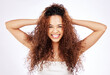 © peopleimages.com - Portrait, woman and hair care by white background for cosmetic, growth and beauty or glow in studio. Happy, face and gen z female person with smile for keratin treatment, curl or frizz transformation