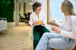 © Guille Faingold/Stocksy - Office conversation during break