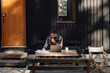 © Ivona Zivulj/Stocksy - Handsome Man Sitting in Front of Mountain Cabin and Working on Laptop