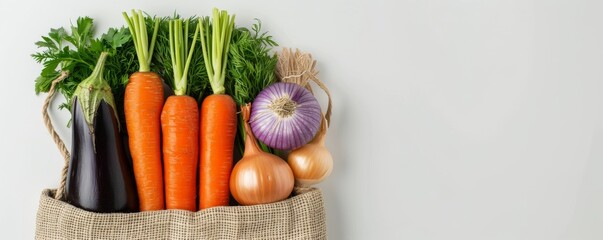 Wall Mural - A variety of fresh vegetables, including carrots, onions, and eggplant, arranged in an eco-friendly bag on a white background. Fresh Vegetables in Eco-Friendly Bag Banner with copy space