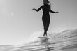 © Nicole Mason/Stocksy - young woman cross stepping surfing on long board on small wave