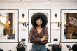 © Santi Nuñez/Stocksy - hairdresser talking to client after cutting and styling afro hair