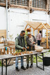 © BONNINSTUDIO/Stocksy - Volunteers working in an urban organic Community Garden